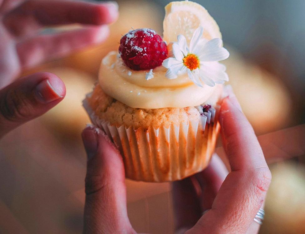 a cupcake held aloft